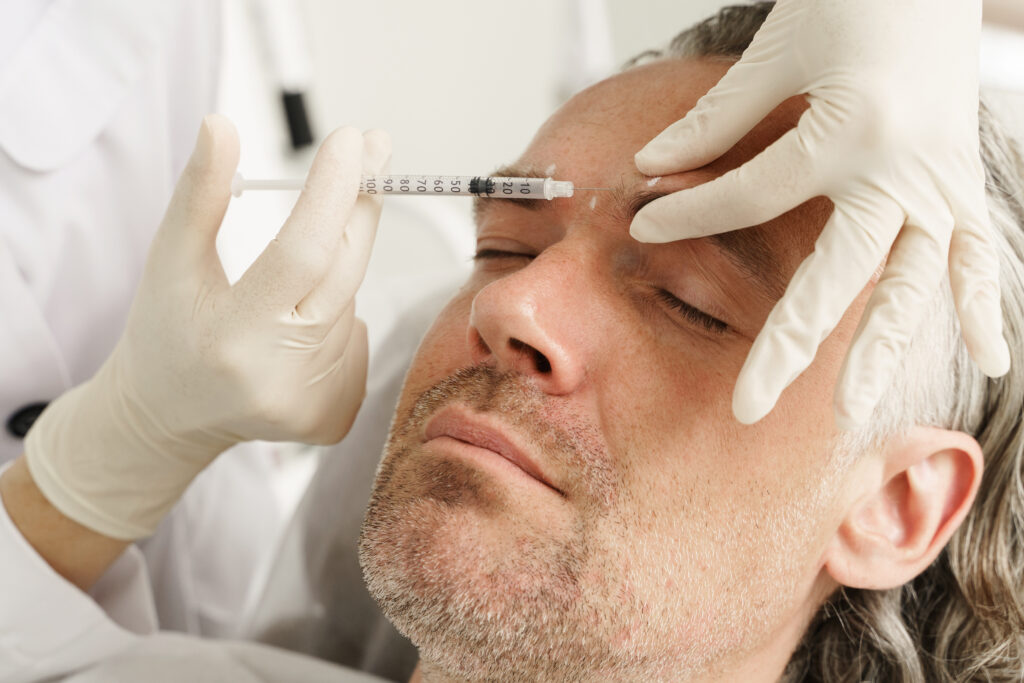 middle aged male client during filler injections aesthetic medical clinic