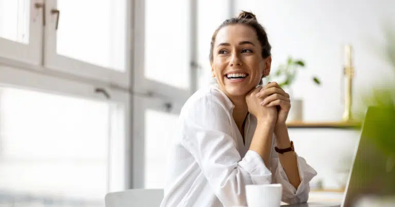 Smiling woman relaxing during a consultation.
